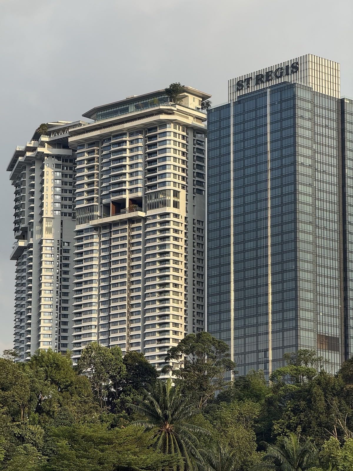 The St. Regis tower at KL Sentral, above the trees of the Lake Gardens side.