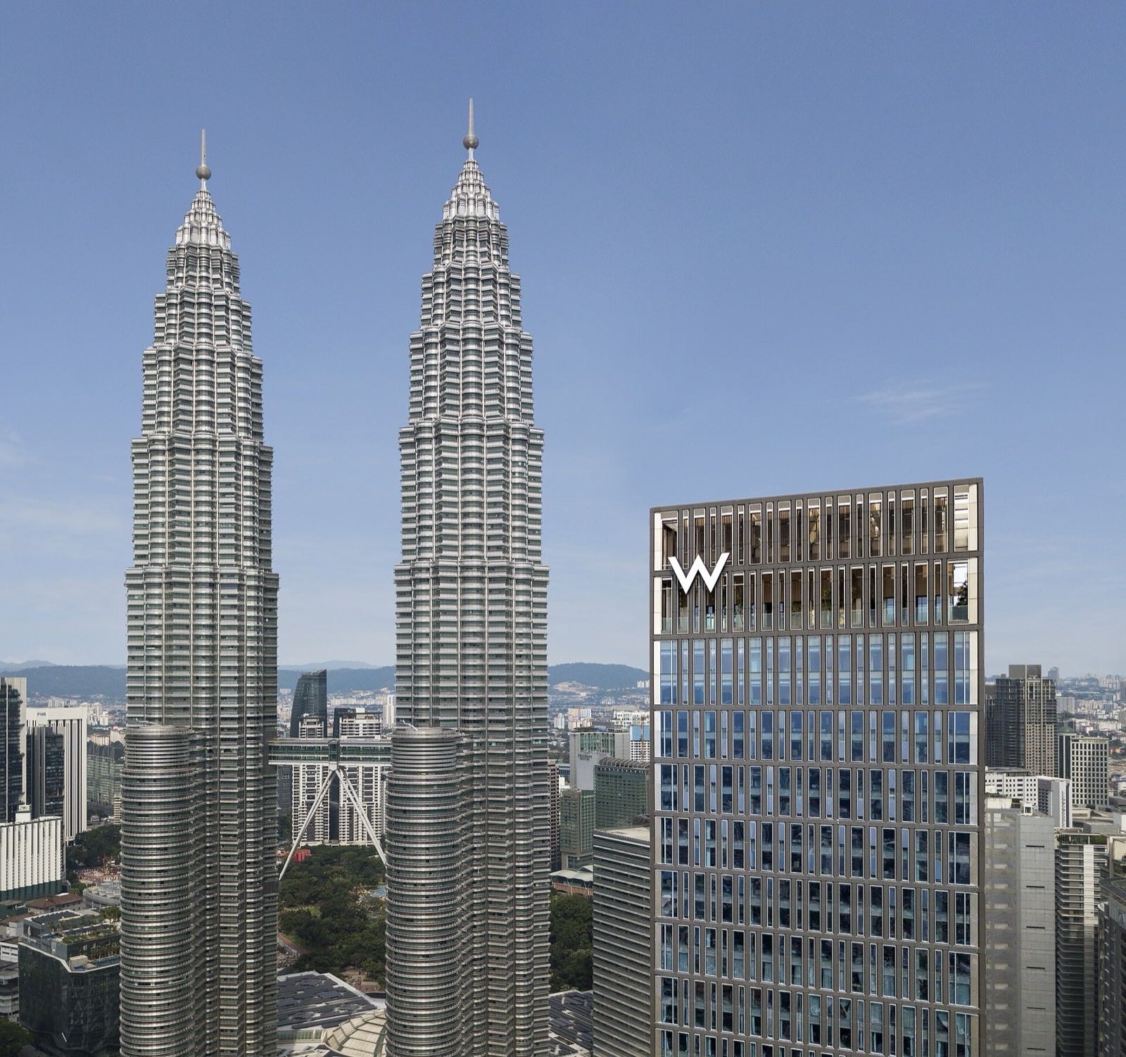 W Kuala Lumpur, right, beside the Petronas Towers.