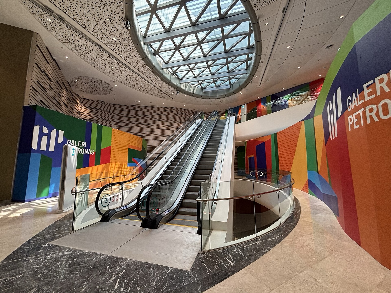 Entrance atrium of the new Galeri PETRONAS inside Ombak KLCC, with its colour-block signage.