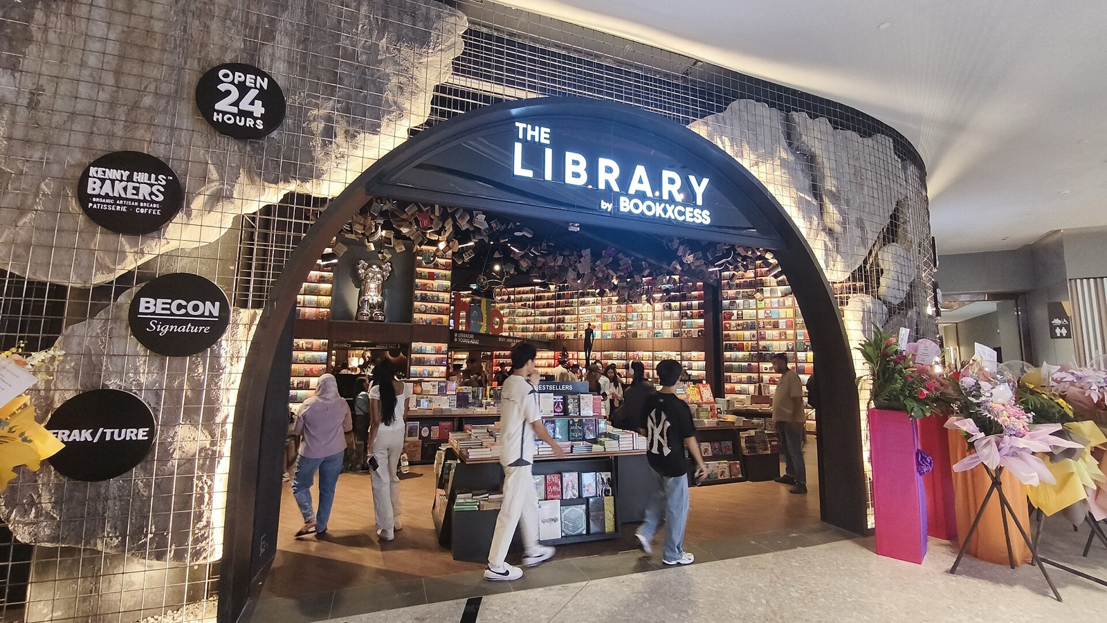 The arched entrance of The Library by BookXcess at Sunway Square Mall, marked Open 24 Hours.