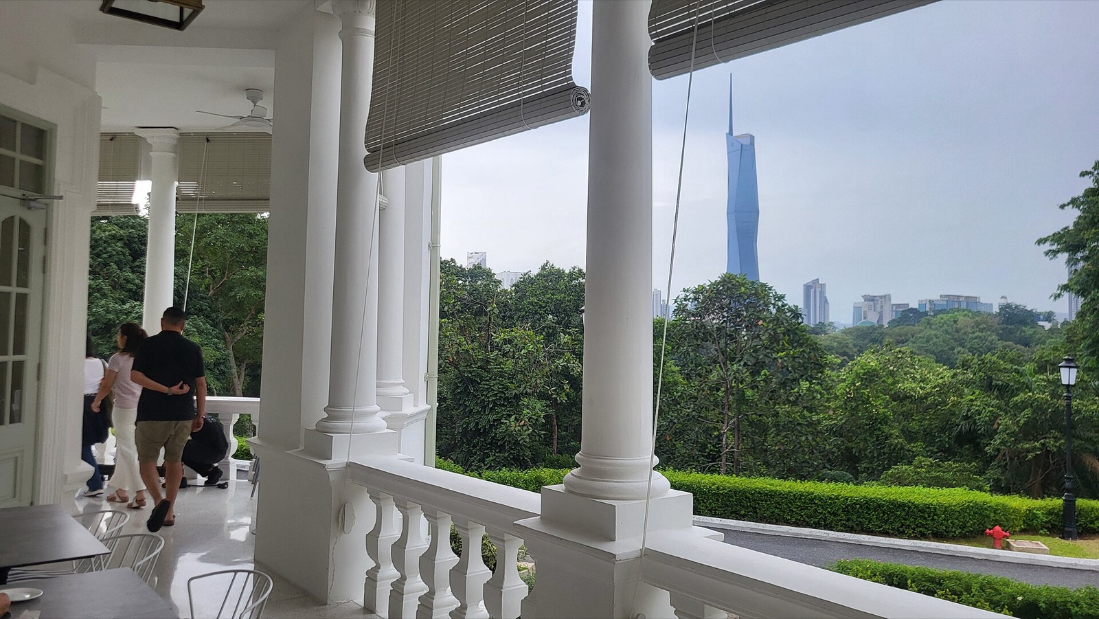 The white colonnaded verandah of Seri Negara, looking over the Lake Gardens treetops to Merdeka 118.